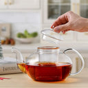 Chaleira de vidro com infusor 800ml sobre chama de fogão com chá borbulhando - Casa Splêndida
