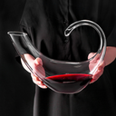 Decanter de cristal com copos para vinho, em mesa sofisticada. Ideal para servir e decorar com elegância.