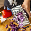 Ralador profissional de legumes em inox com 4 lâminas intercambiáveis e alça antiderrapante.