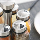 conjunto giratório de porta temperos com seis frascos de vidro e tampas inox sobre bancada – Casa Splendida