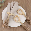 Porta-guardanapo artesanal com contas de madeira natural e tassel de juta – estilo boho e rústico para mesa posta elegante.
