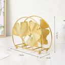 Porta‑guardanapos metálico dourado com folhas de ginkgo