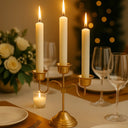 Mesa posta refinada com candelabro dourado, velas altas e arranjo floral branco, decoração Casa Splendida.
