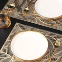 Composição elegante com jogo americano dourado e louças azuis, criando mesa posta luxuosa e contemporânea.