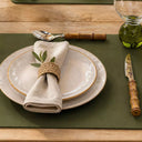 Jogo americano verde em courino com prato e guardanapo elegante sobre a mesa
