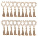 Porta-guardanapo artesanal com contas de madeira natural e tassel de juta – estilo boho e rústico para mesa posta elegante.

