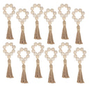 Porta-guardanapo artesanal com contas de madeira natural e tassel de juta – estilo boho e rústico para mesa posta elegante.

