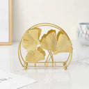 Porta‑guardanapos metálico dourado com folhas de ginkgo